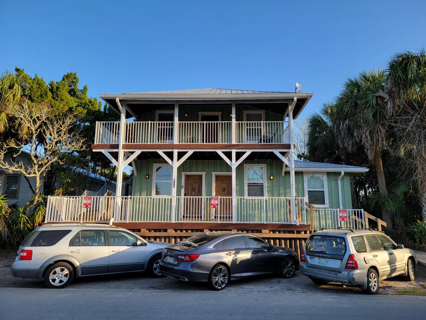 The historic green Vacation Nature Coast building at 634 6th Street, Cedar Key